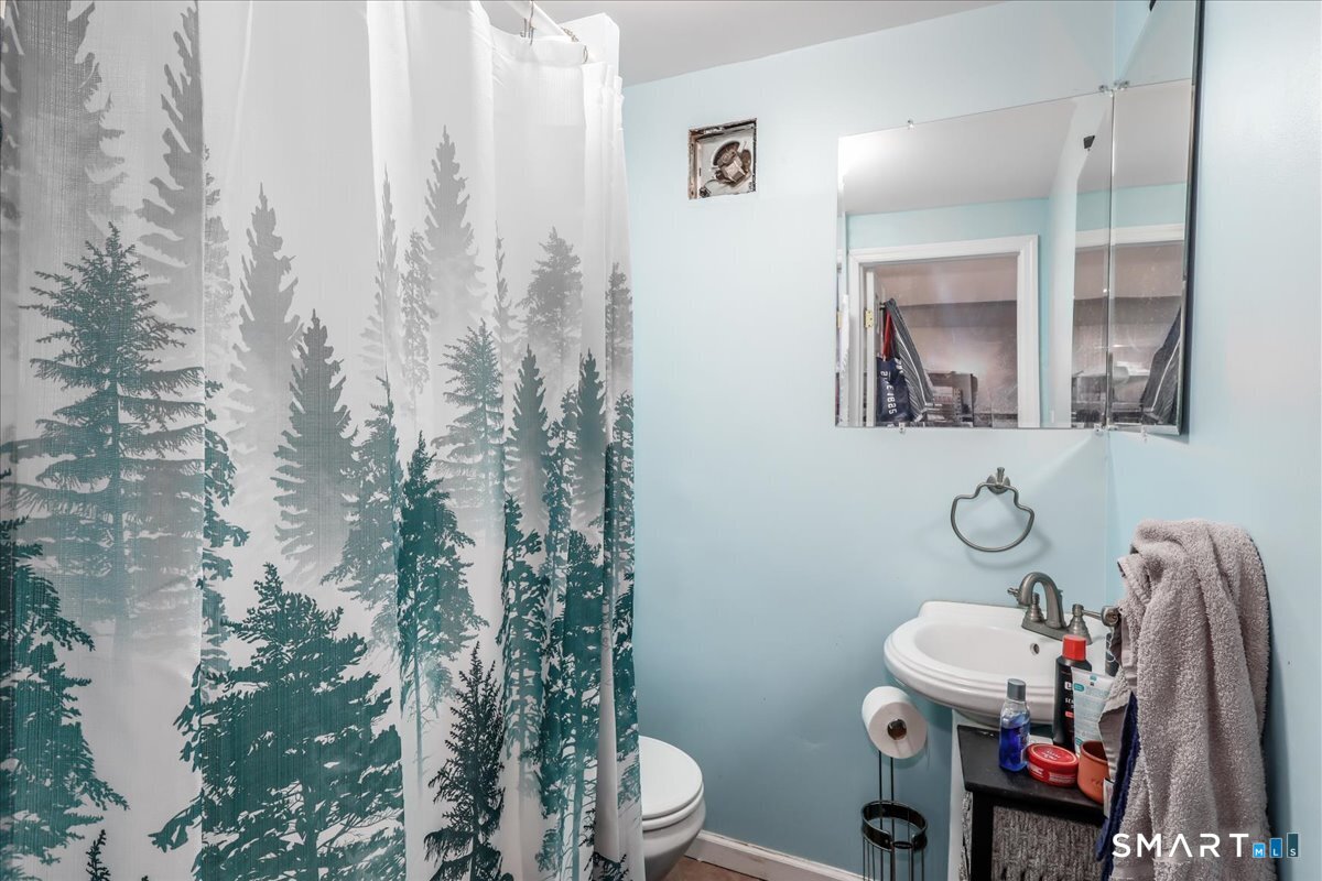 55 A Flax Hill Road Brookfield, CT 06804 - Photo 34 of 40 a bathroom with a toilet mirror and shower curtain