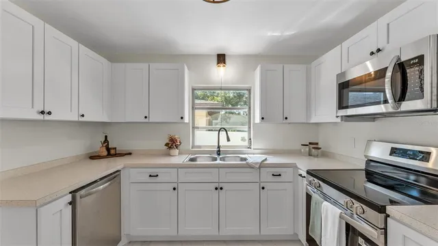a kitchen with cabinets and window