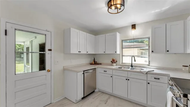 an empty room with wooden floor closet and fan