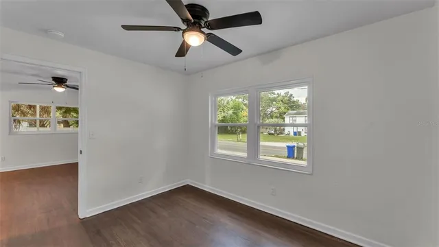 a view of an empty room with wooden floor