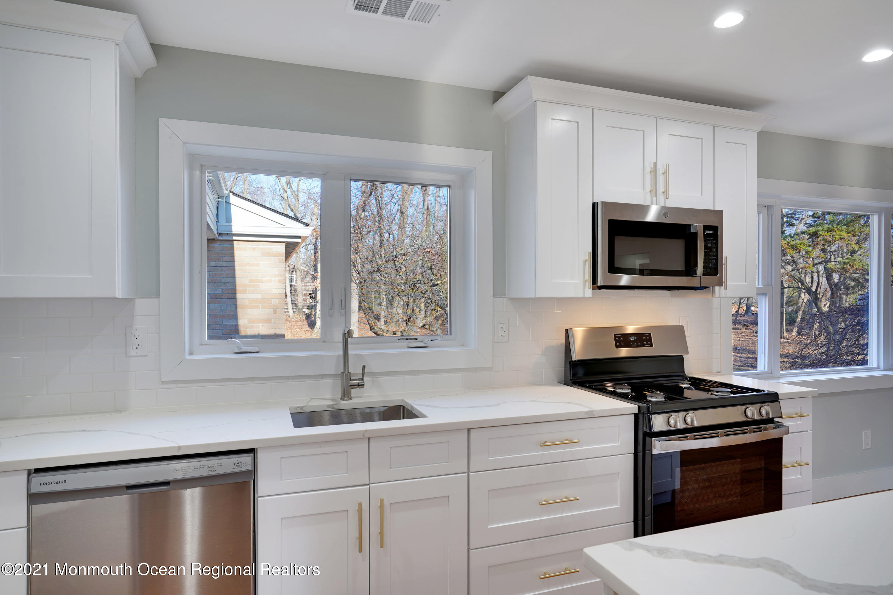 1155 Crim Road Bridgewater, NJ 08807 - Photo 12 of 29 a kitchen with granite countertop a sink cabinets stainless steel appliances and a window