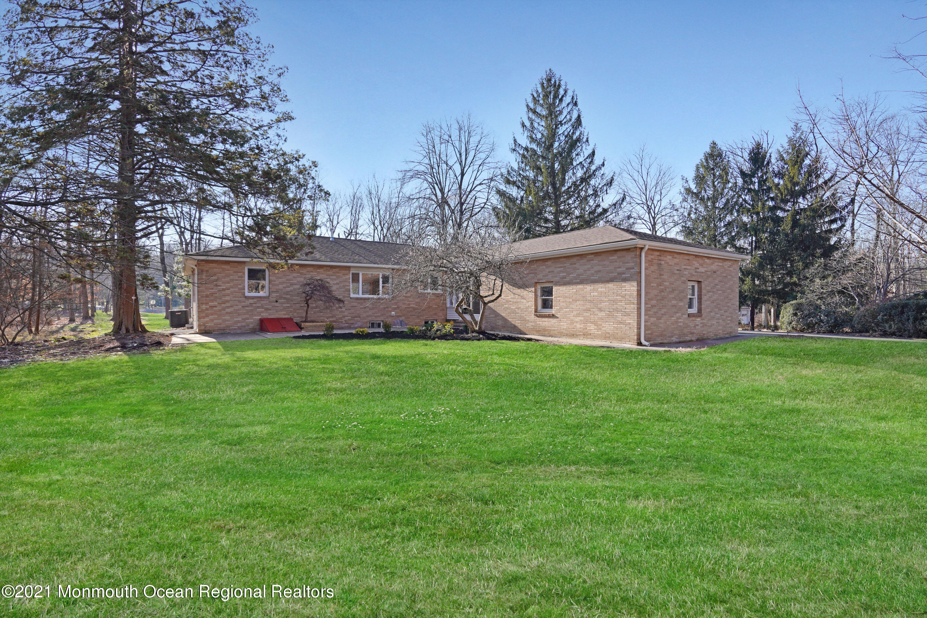1155 Crim Road Bridgewater, NJ 08807 - Photo 29 of 29 a view of a brick house with a big yard and large trees