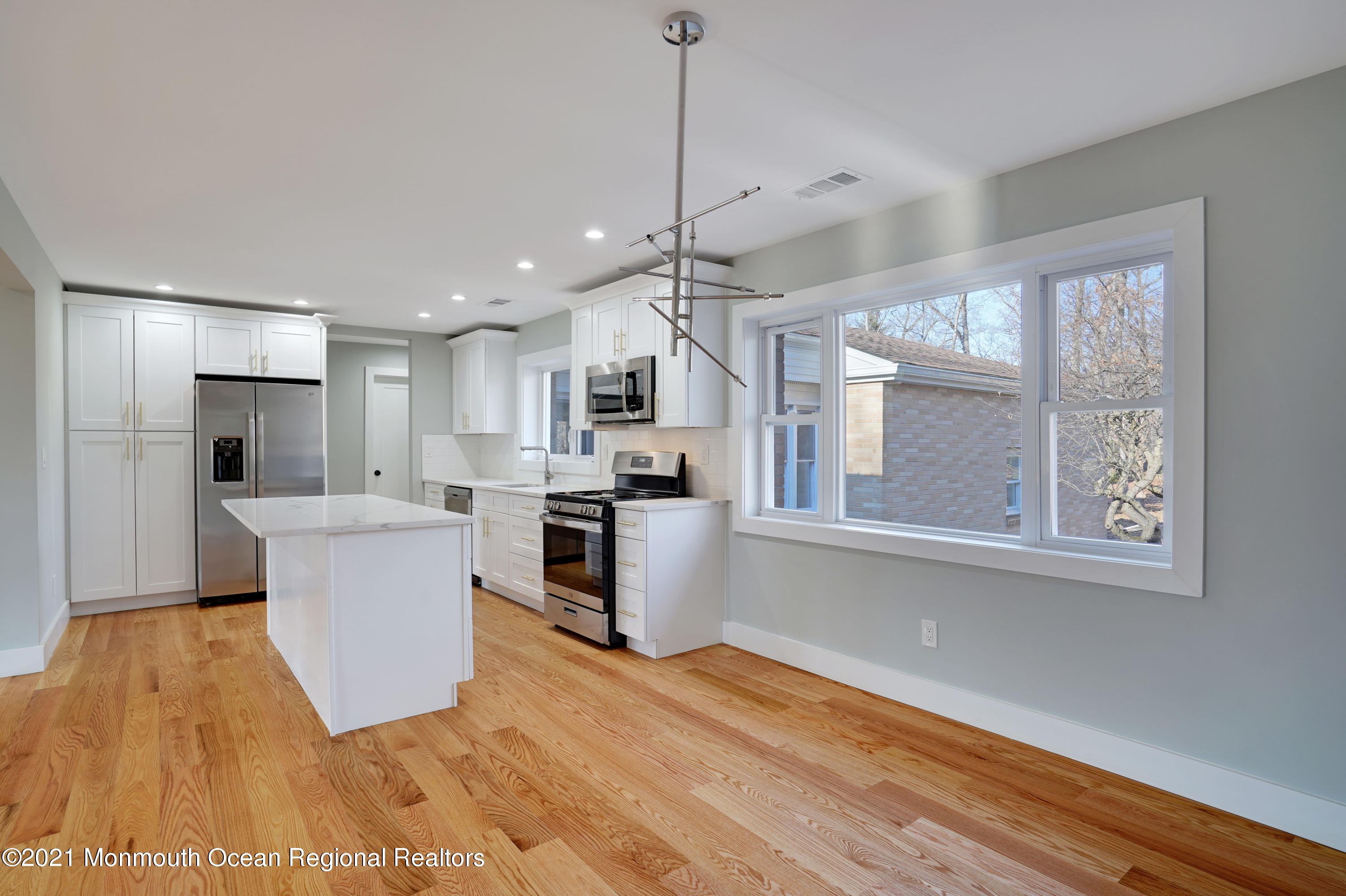 1155 Crim Road Bridgewater, NJ 08807 - Photo 9 of 29 a kitchen with kitchen island white cabinets and refrigerator