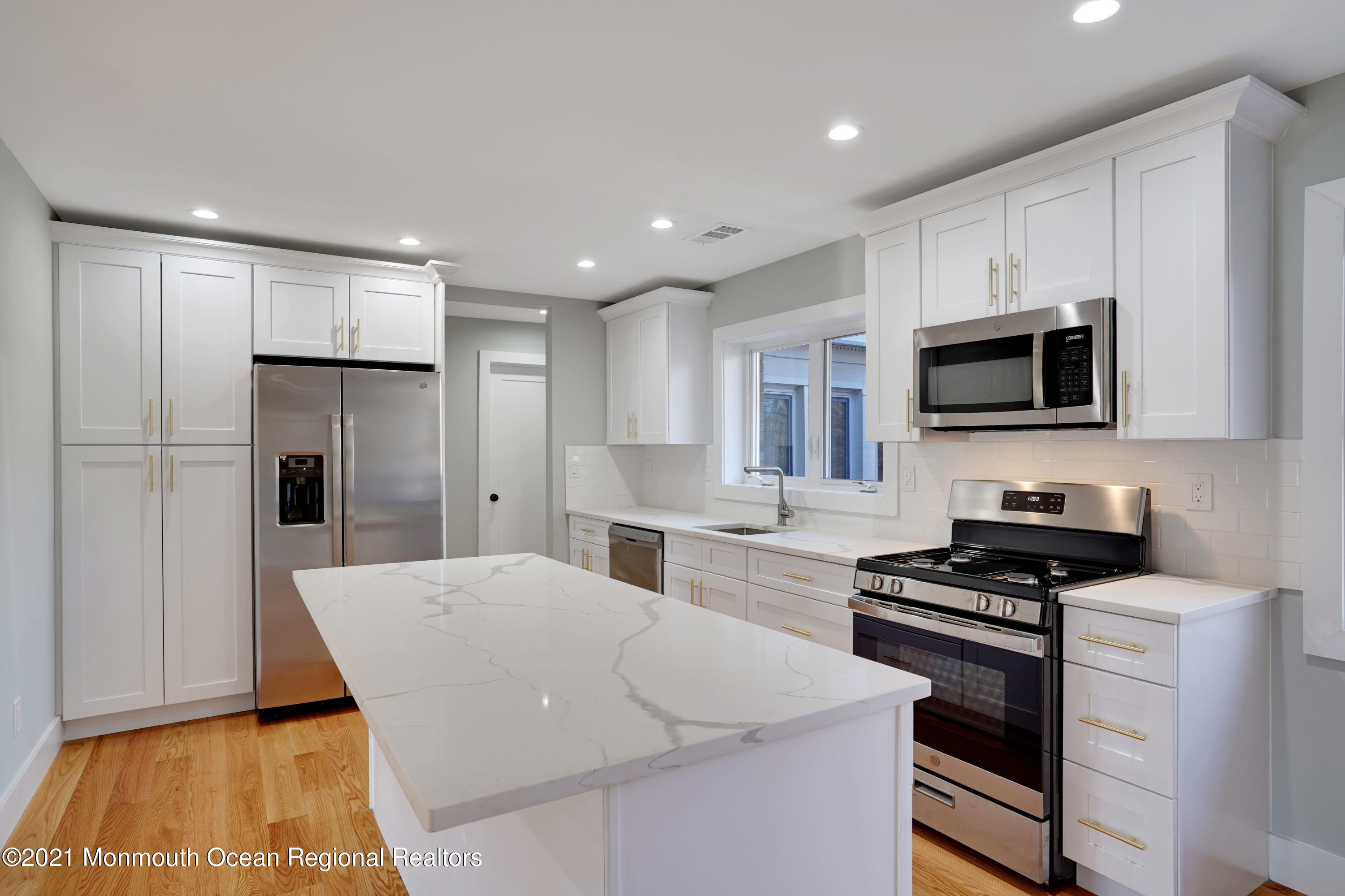 1155 Crim Road Bridgewater, NJ 08807 - Photo 10 of 29 a kitchen with stainless steel appliances kitchen island granite countertop a refrigerator oven a sink dishwasher and white cabinets with wooden floor