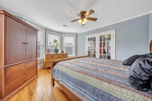 a bedroom with a bed and a chandelier
