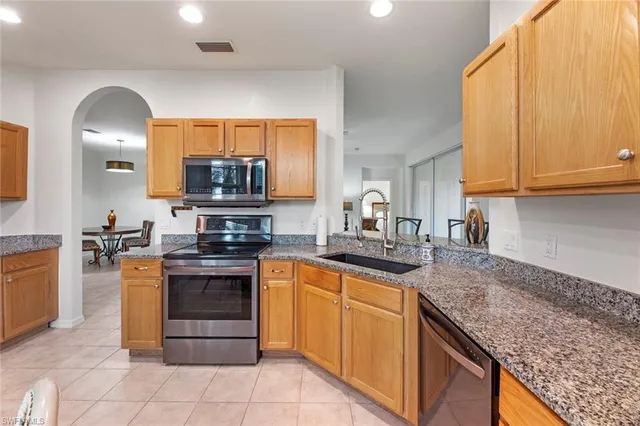 a kitchen with stainless steel appliances granite countertop a sink stove and oven