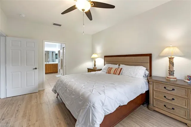 a bedroom with a bed and a lamp