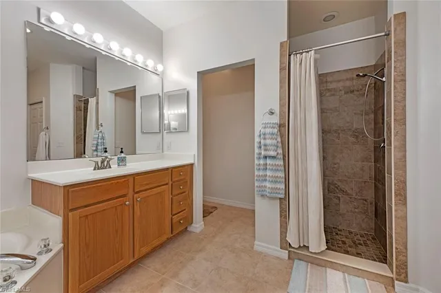 a bathroom with a double vanity sink mirror and shower
