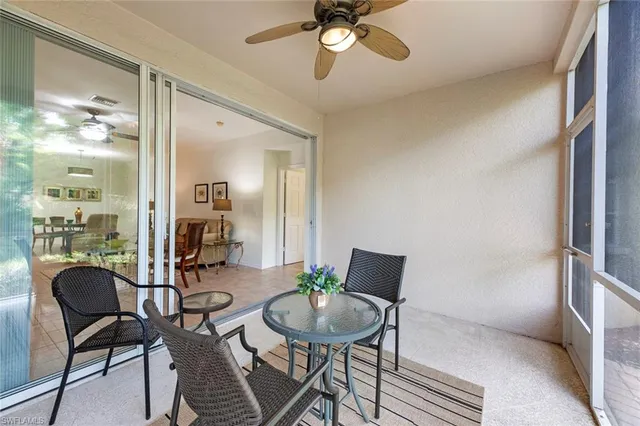 a view of a livingroom with furniture and a dining table with wooden floor
