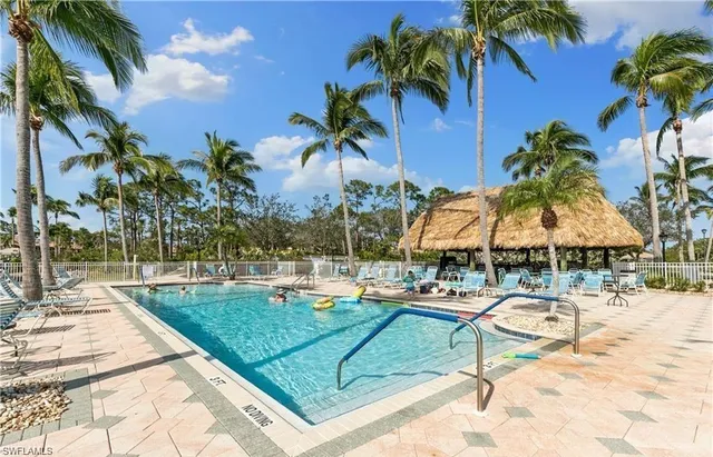 a swimming pool with outdoor seating and yard
