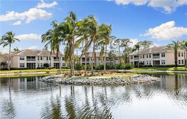 a view of a swimming pool with a lawn chairs under an umbrella