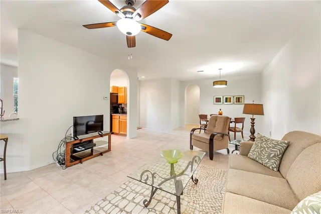 a living room with furniture and kitchen view