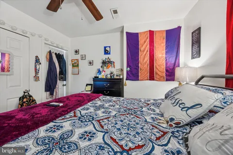 a bathroom with a toilet sink vanity granite and mirror