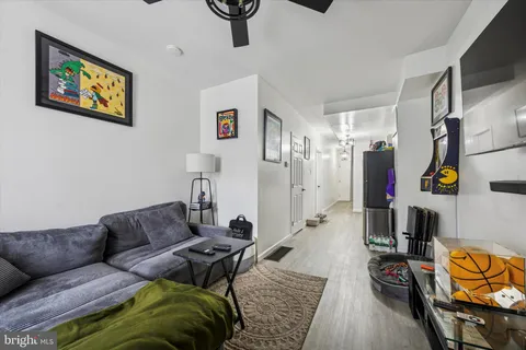 a living room with furniture a rug and a chandelier