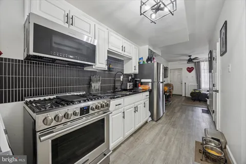 a kitchen with stainless steel appliances granite countertop a sink and cabinets