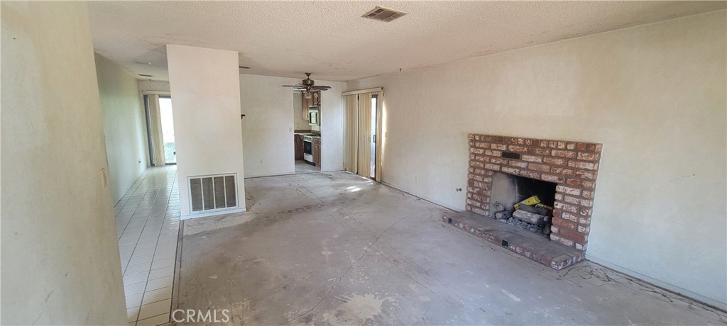 4 Dearborn Circle Redlands, CA 92374 - Photo 5 of 17 a view of a hallway with wooden floor and a fireplace