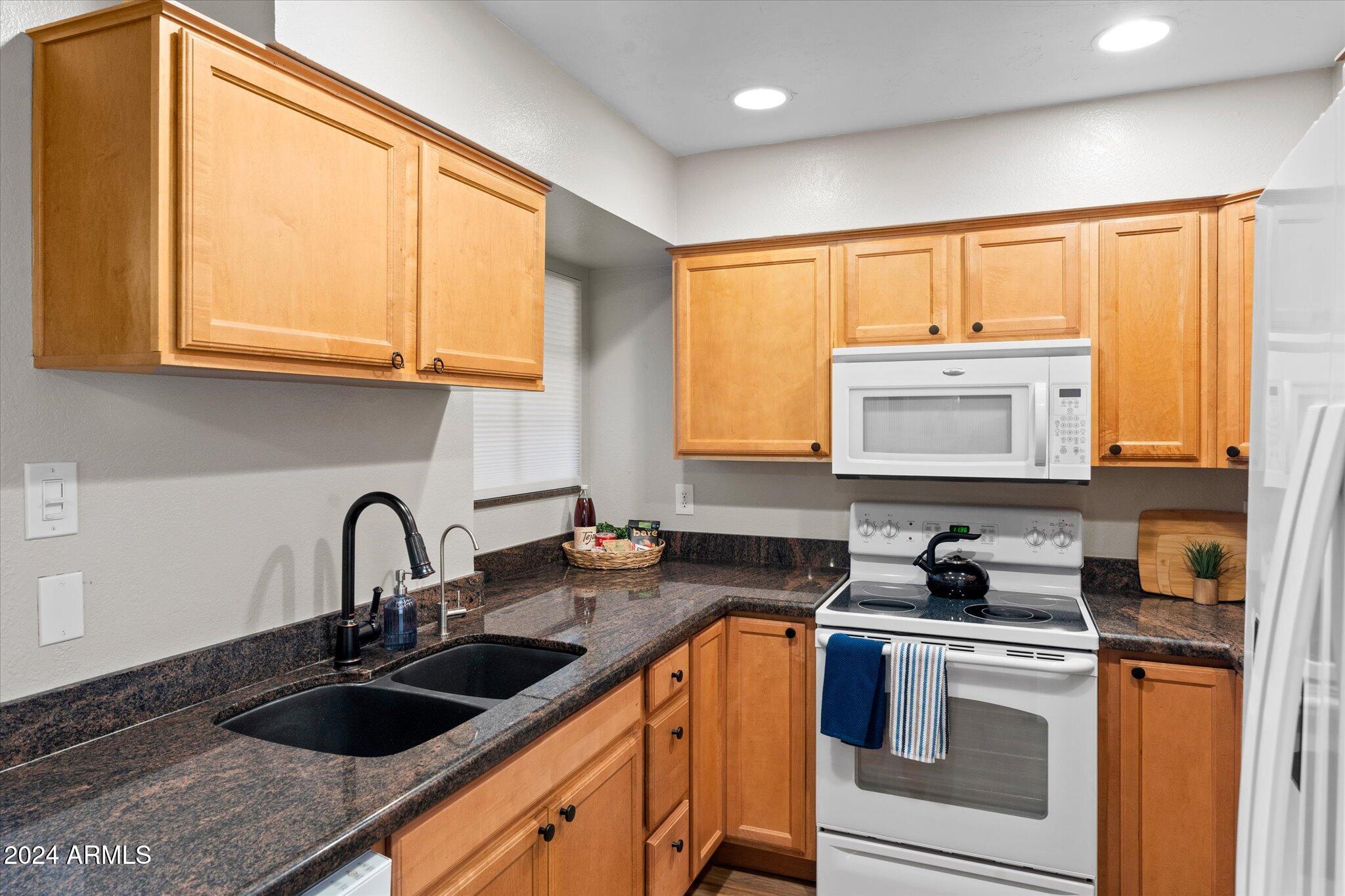533 West Guadalupe Road, Unit 1063 Mesa, AZ 85210 - Photo 19 of 57 a kitchen with a sink a stove and cabinets