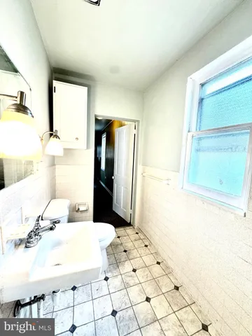 a bathroom with a sink mirror toilet and shower