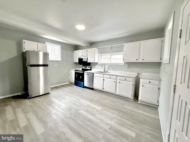 a kitchen with stainless steel appliances a refrigerator sink and cabinets