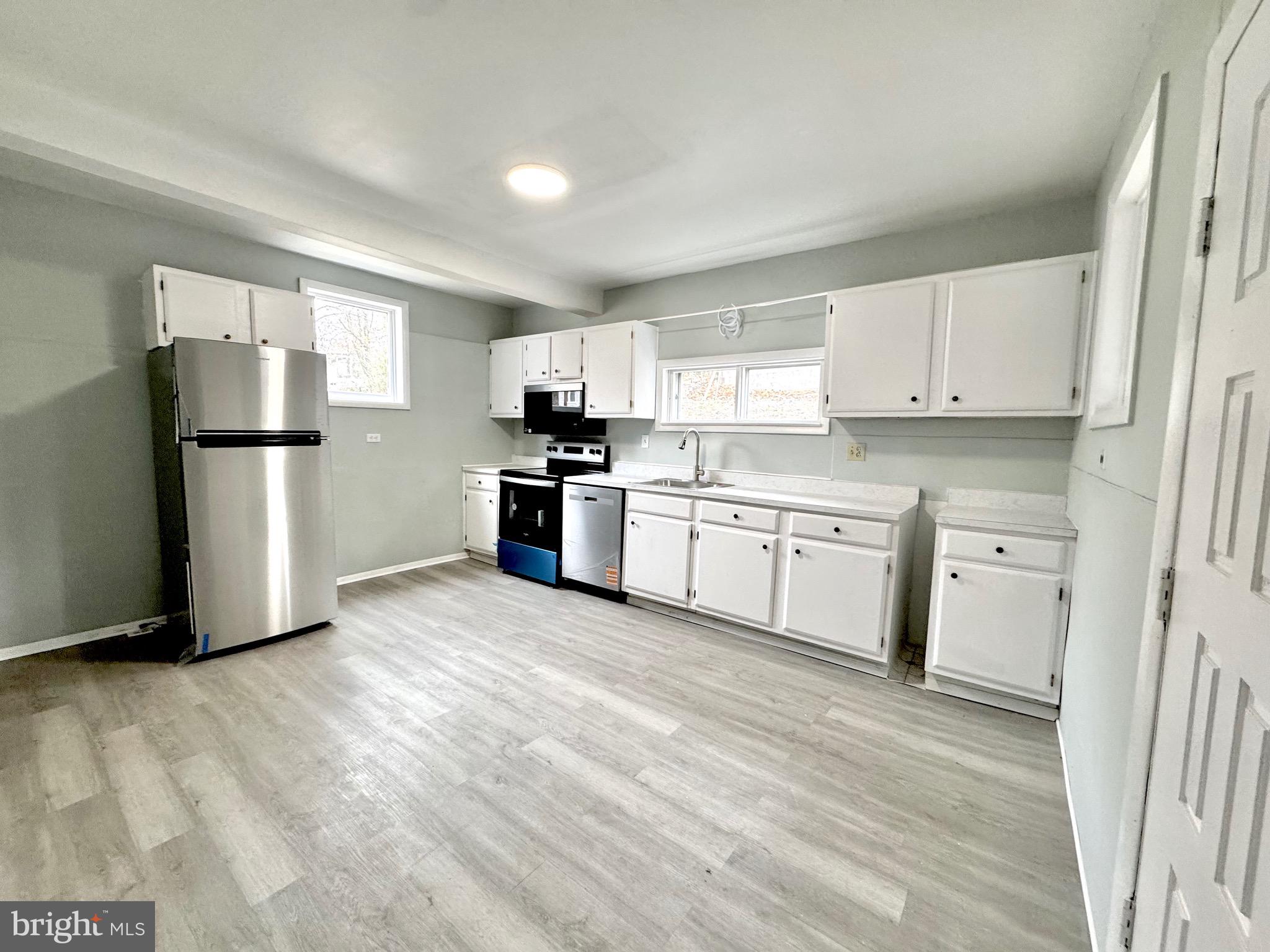467 Goethe Street Cumberland, MD 21502 - Photo 7 of 19 a kitchen with stainless steel appliances a refrigerator sink and cabinets