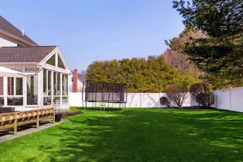 a view of a house with a yard and sitting area