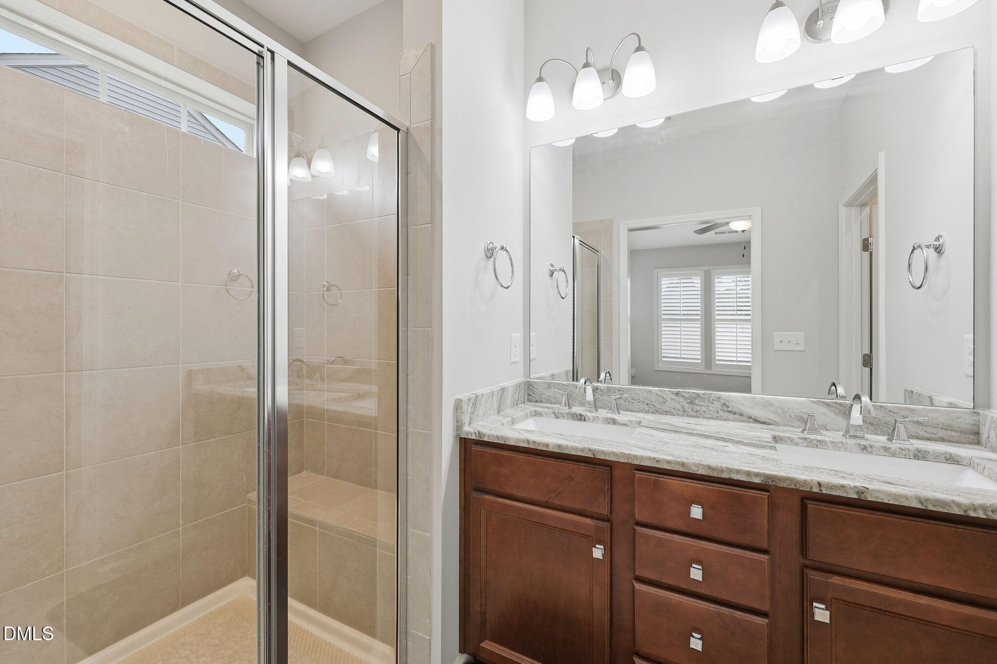 522 Brunello Drive Wake Forest, NC 27587 - Photo 11 of 24 a bathroom with a granite countertop sink a mirror and a shower