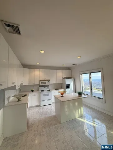 a kitchen with refrigerator cabinets and a sink
