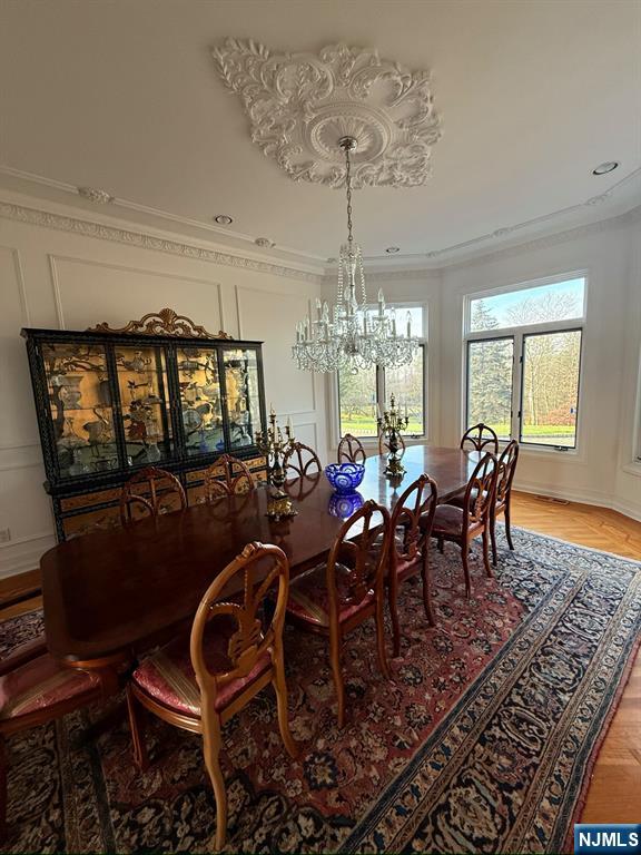 24 Club Way Cedar Grove, NJ 07009 - Photo 6 of 18 a view of a dining room with furniture a chandelier and wooden floor