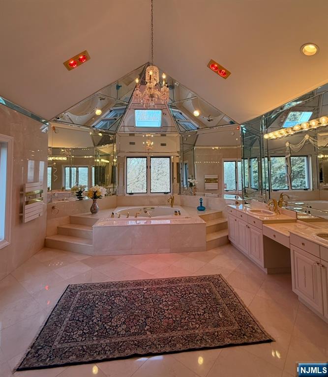 24 Club Way Cedar Grove, NJ 07009 - Photo 10 of 18 a large white kitchen with a large center island a stove a dining table and chairs