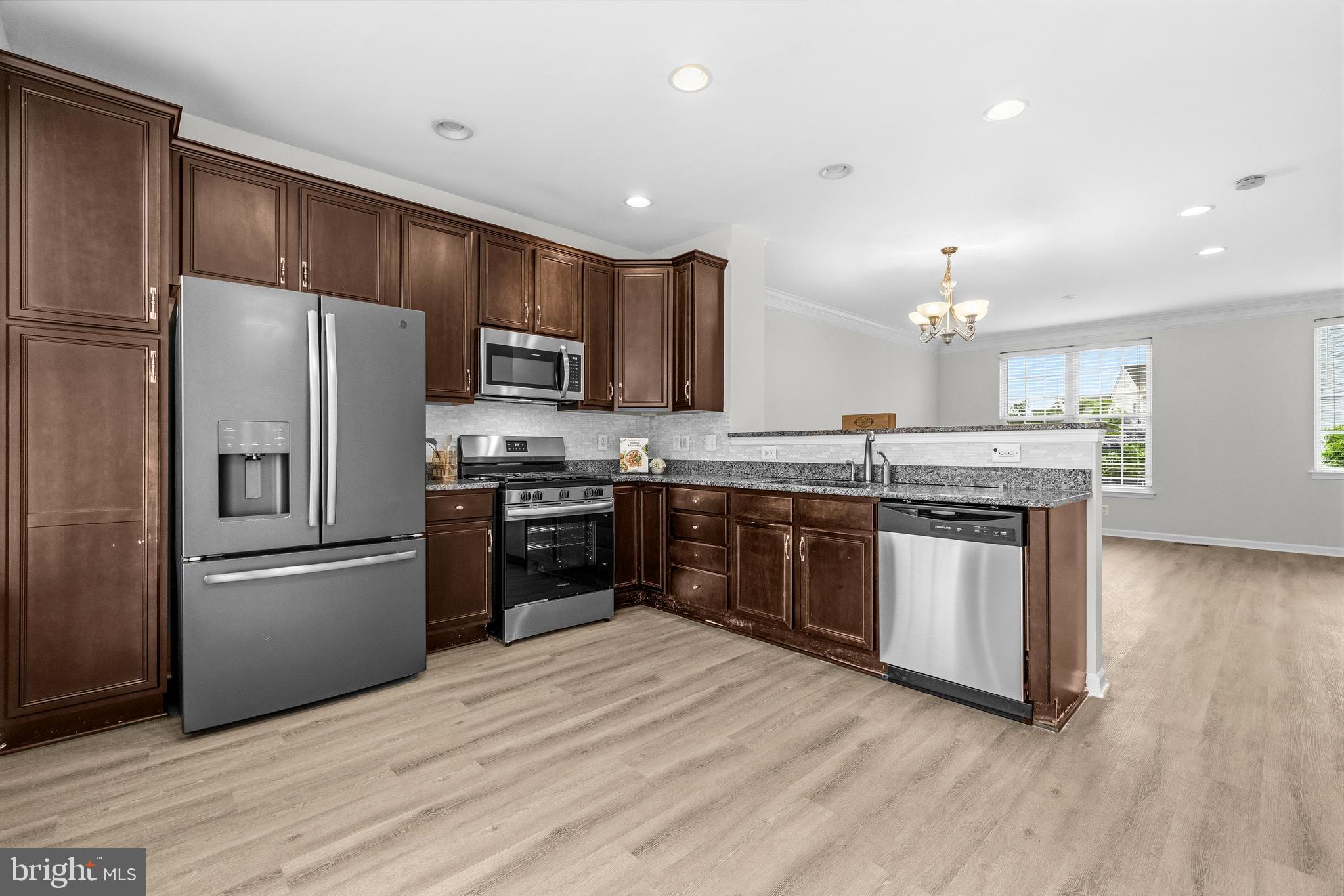 25154 Monteith Terrace Chantilly, VA 20152 - Photo 8 of 40 a kitchen with stainless steel appliances granite countertop a refrigerator stove and oven