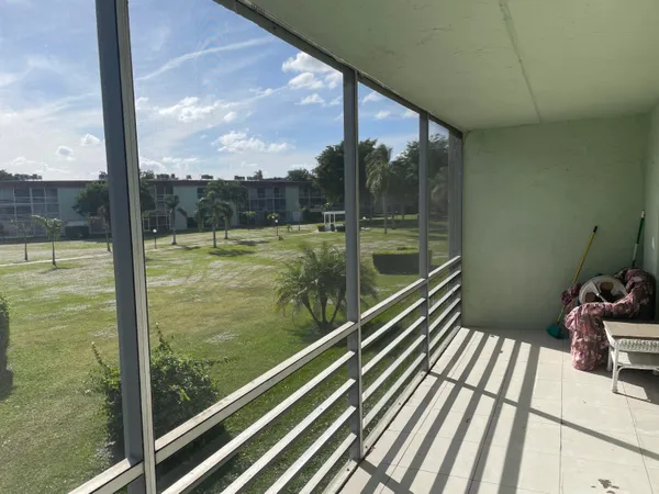 a view of a balcony with floor to ceiling windows with wooden floor