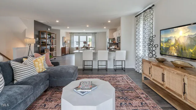 a living room with furniture a rug and a lamp