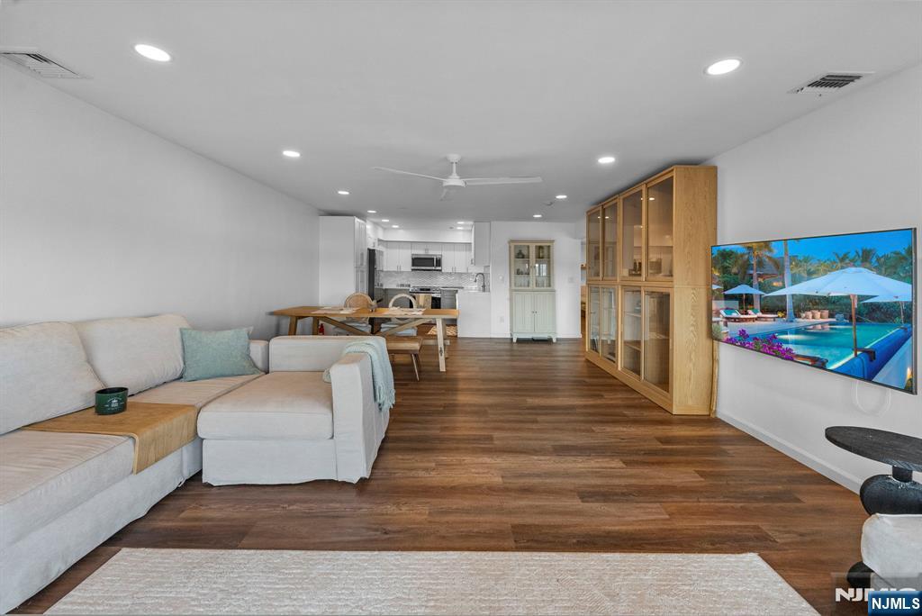 101 Highway 5, Unit 206 Edgewater, NJ 07020 - Photo 11 of 48 a living room with furniture and a wooden floor