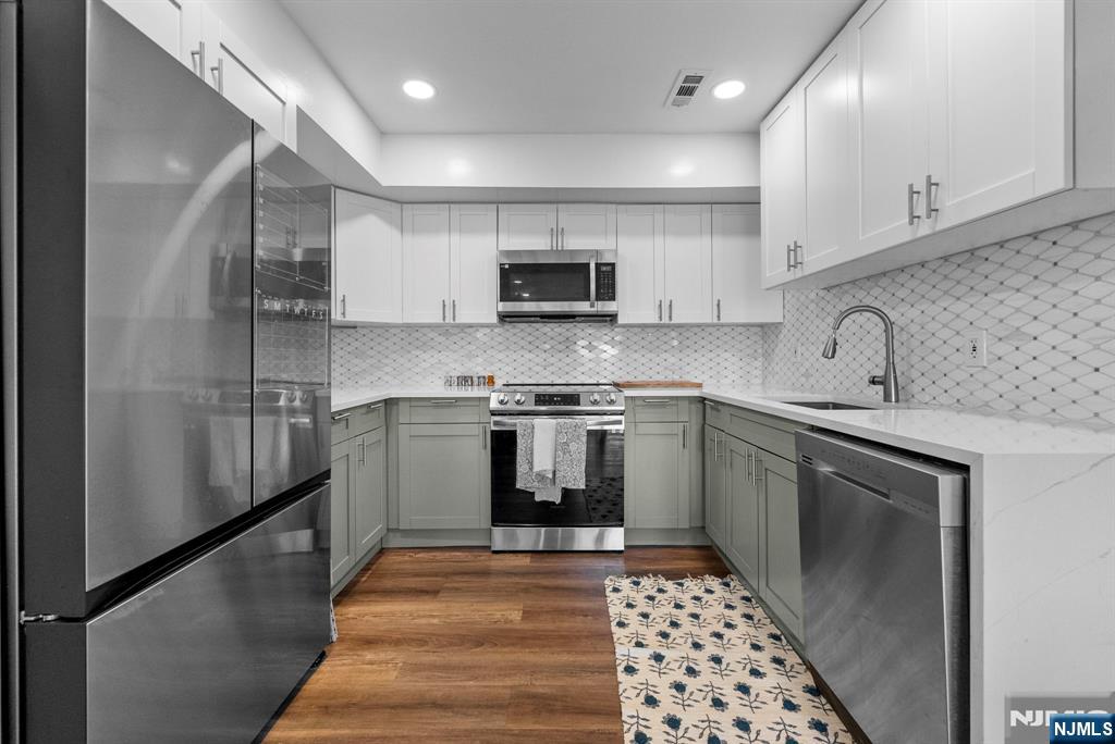 101 Highway 5, Unit 206 Edgewater, NJ 07020 - Photo 12 of 48 a kitchen with granite countertop a refrigerator and a sink