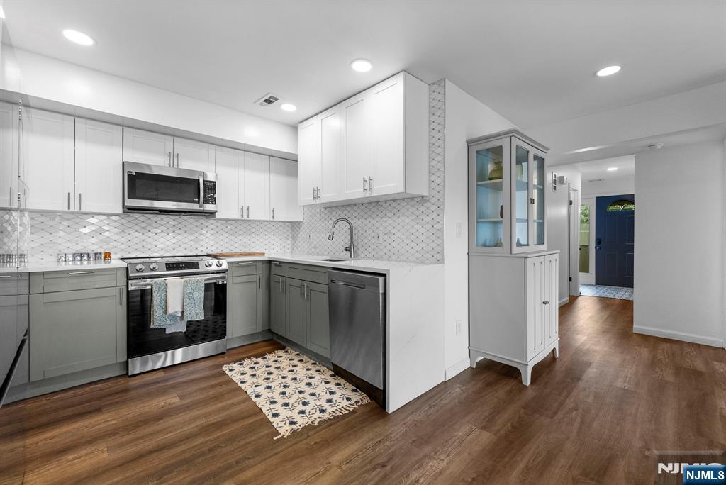 101 Highway 5, Unit 206 Edgewater, NJ 07020 - Photo 13 of 48 a kitchen with granite countertop a refrigerator and a stove top oven