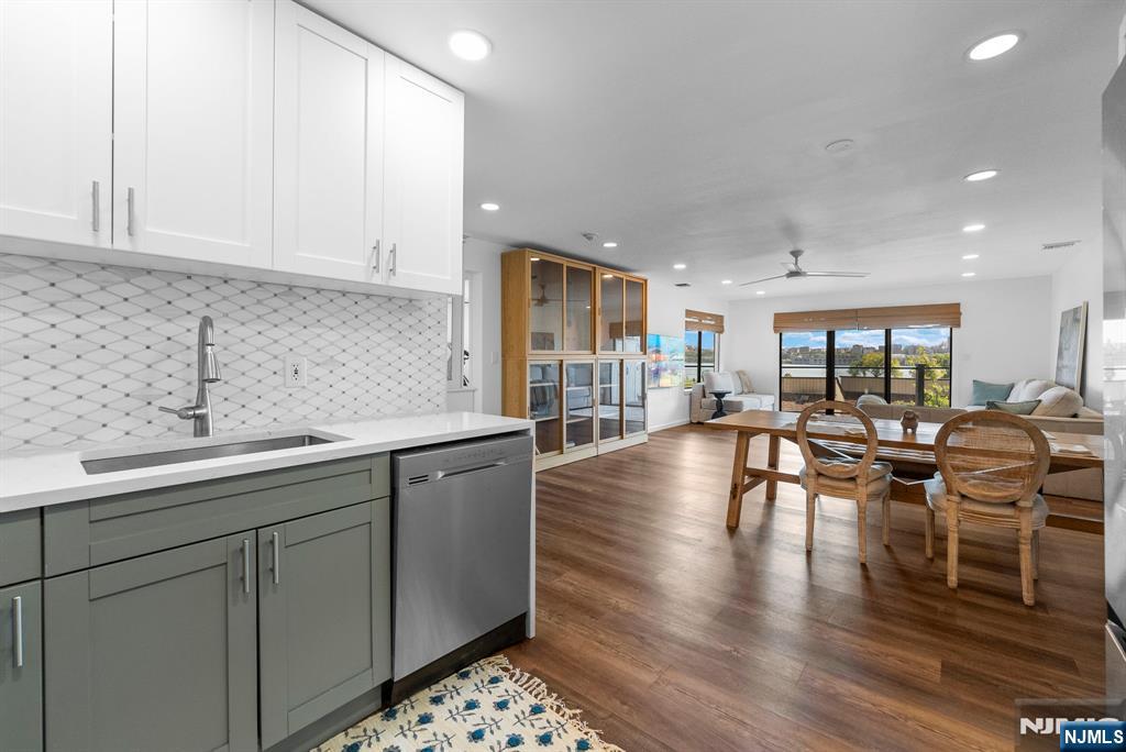 101 Highway 5, Unit 206 Edgewater, NJ 07020 - Photo 15 of 48 a kitchen with stainless steel appliances granite countertop a stove and white cabinets