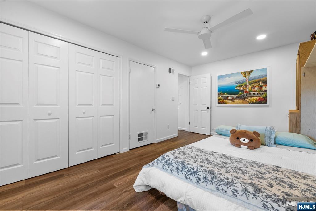 101 Highway 5, Unit 206 Edgewater, NJ 07020 - Photo 19 of 48 a bedroom with a bed and wooden floor