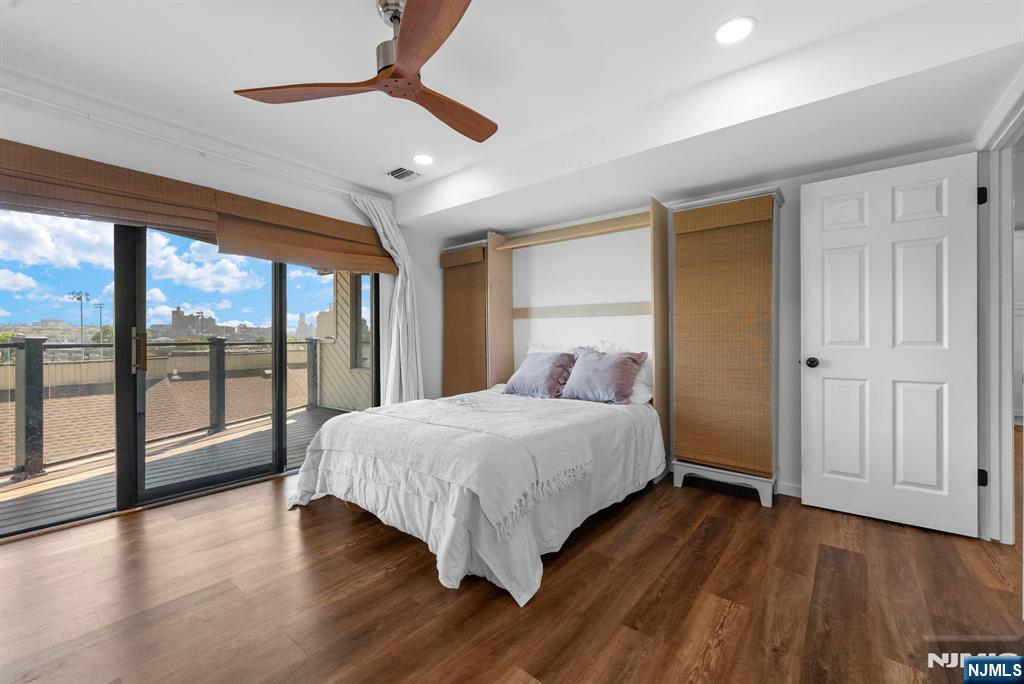 101 Highway 5, Unit 206 Edgewater, NJ 07020 - Photo 23 of 48 a bedroom with a large bed and a large window