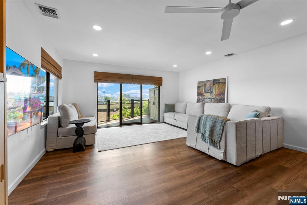 101 Highway 5, Unit 206 Edgewater, NJ 07020 - Photo 3 of 48 a living room with furniture and a flat screen tv