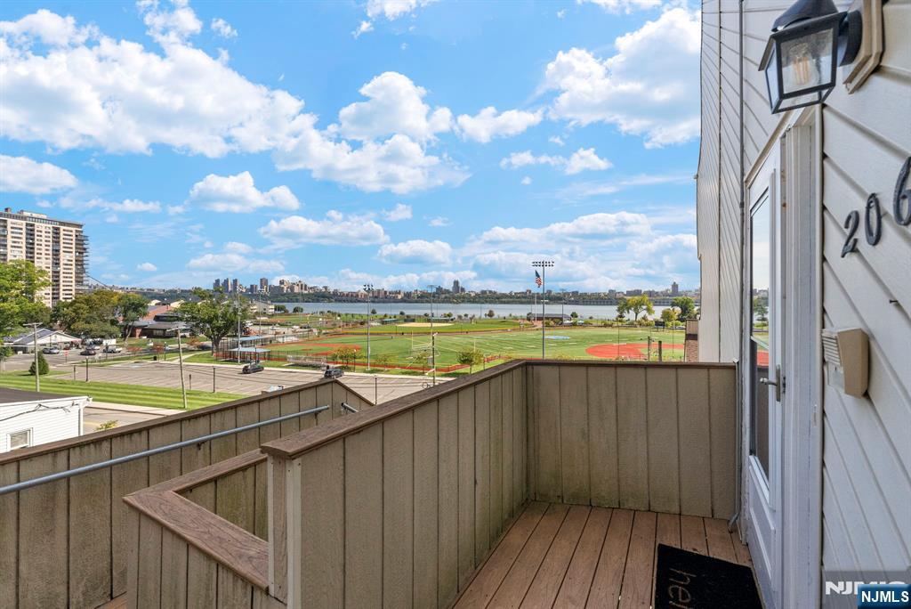 101 Highway 5, Unit 206 Edgewater, NJ 07020 - Photo 34 of 48 a view of swimming pool with outdoor seating and city view