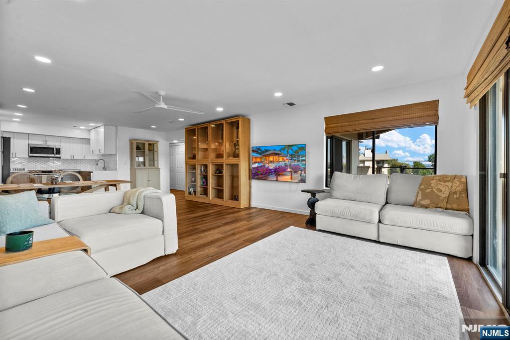 101 Highway 5, Unit 206 Edgewater, NJ 07020 - Photo 5 of 48 a living room with furniture and a flat screen tv