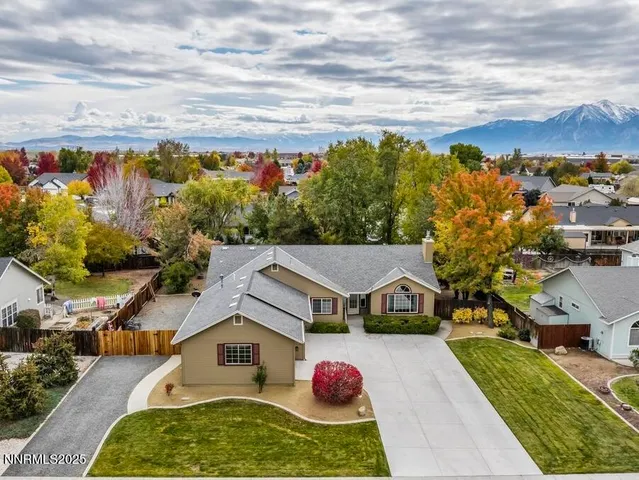 a aerial view of a house with table and chairs