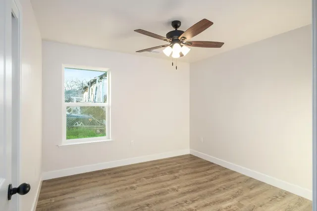wooden floor in an empty room with a window
