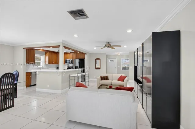 a kitchen with a sink refrigerator and cabinets