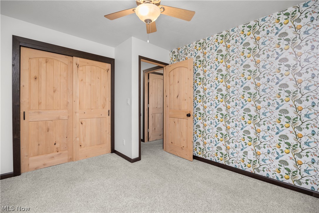6760 Mason Road Berlin Heights, OH 44814 - Photo 22 of 49 Unfurnished bedroom featuring carpet floors, a closet, ceiling fan, and wallpapered walls