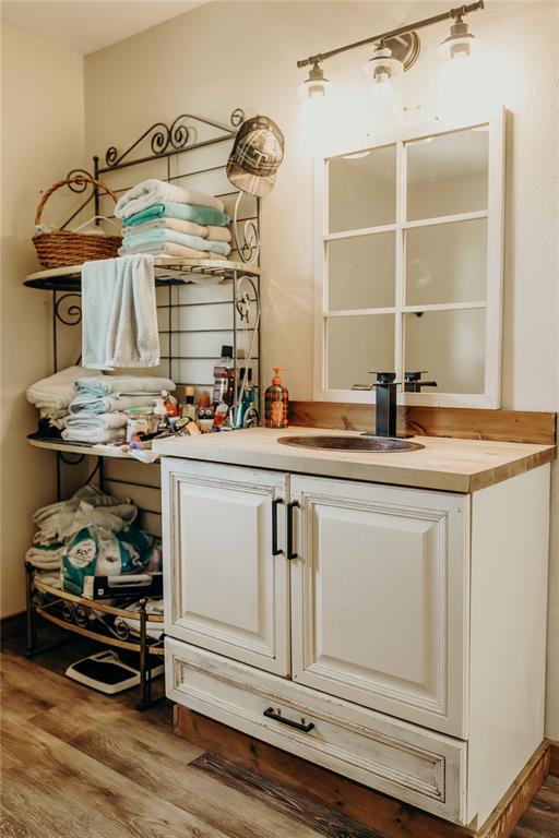1740 Highway 2247 Comanche, TX 76442 - Photo 16 of 38 Bar area with wood finished floors and a sink