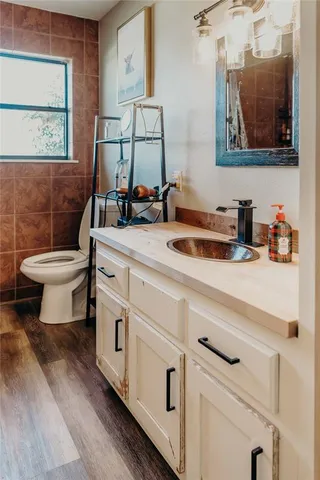 a bathroom with a toilet sink and mirror