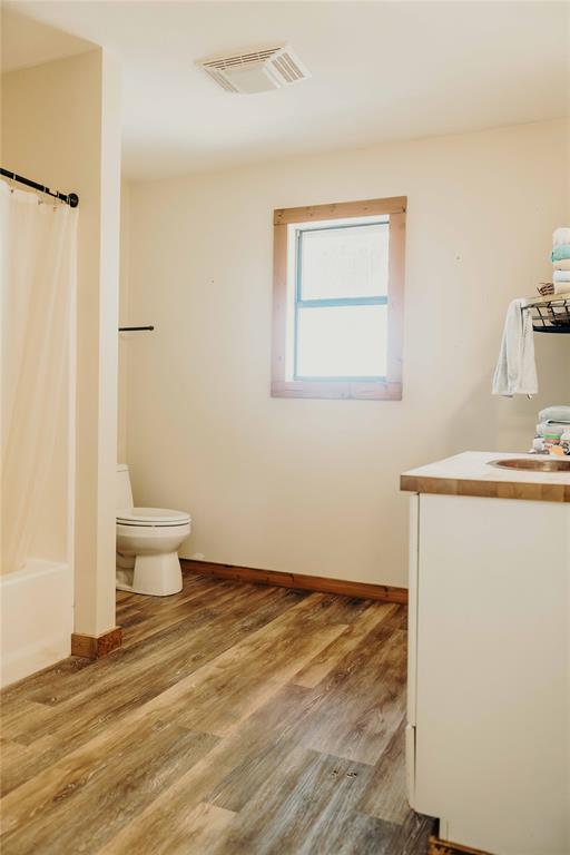 1740 Highway 2247 Comanche, TX 76442 - Photo 25 of 38 Bathroom with vanity, wood finished floors, and shower / tub combo