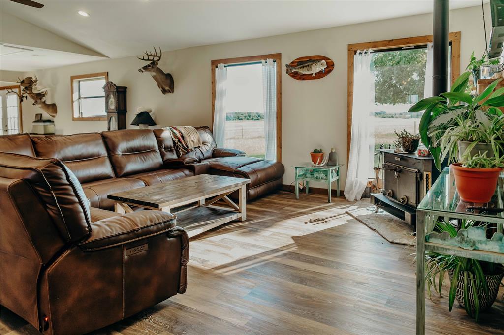1740 Highway 2247 Comanche, TX 76442 - Photo 4 of 38 Living area featuring healthy amount of natural light, recessed lighting, wood finished floors, lofted ceiling, and a ceiling fan