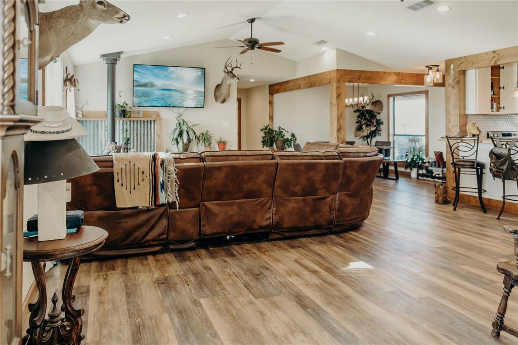 1740 Highway 2247 Comanche, TX 76442 - Photo 5 of 38 Living room with ceiling fan, light wood-type flooring, lofted ceiling, ornate columns, and recessed lighting